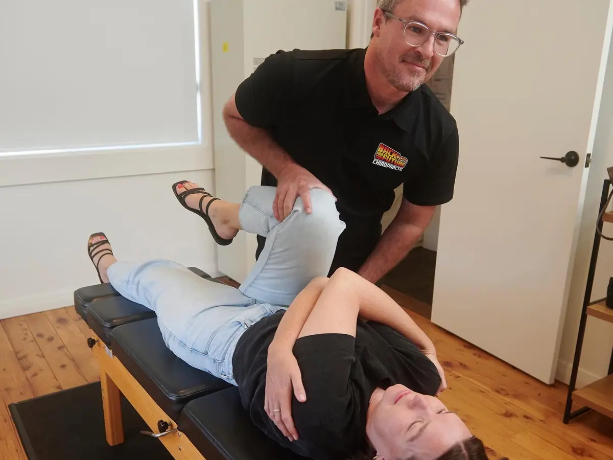Chiropractor performing a lower back adjustment